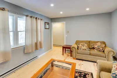 a living room with a couch and a table at Cozy Southern Vermont Home with On-Site Trails in Whitingham