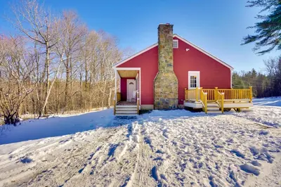 a red barn with snow on the ground at Cozy Southern Vermont Home with On-Site Trails in Whitingham