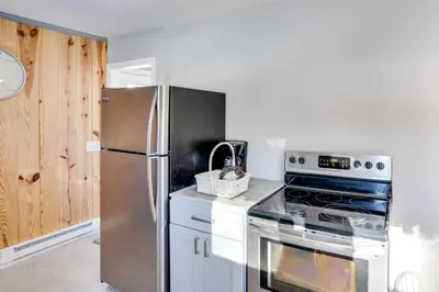 a kitchen with a stainless steel refrigerator and a stove at Cozy Southern Vermont Home with On-Site Trails in Whitingham