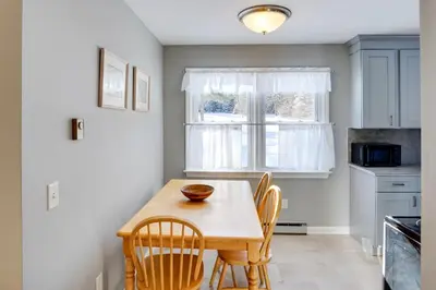 a kitchen with a table and chairs and a window at Cozy Southern Vermont Home with On-Site Trails in Whitingham