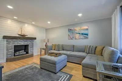 a living room with a couch and a fireplace at Modern Middletown Retreat, Minutes to Downtown! in Middletown