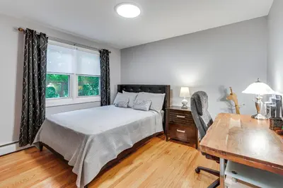 a bedroom with a bed and a desk and a window at Modern Middletown Retreat, Minutes to Downtown! in Middletown
