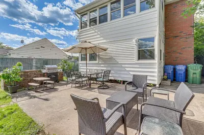 a patio with chairs and a table with an umbrella at Modern Middletown Retreat, Minutes to Downtown! in Middletown