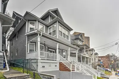 a row of houses on a city street at Pet-Friendly Newark Townhome Near Airport! in Newark