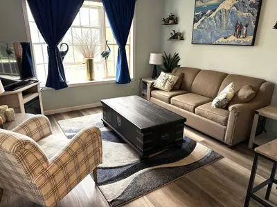 a living room with a couch and a coffee table at WOW-New Ski OnOff Suite By Pool Sleeps 4 Jiminy Pk in Hancock