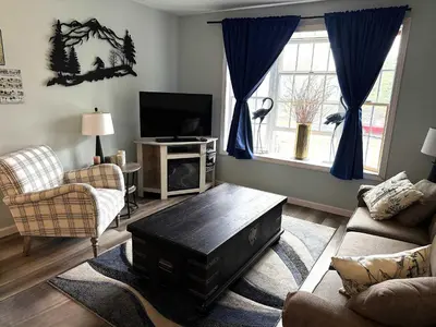 a living room with a couch and a tv at WOW-New Ski OnOff Suite By Pool Sleeps 4 Jiminy Pk in Hancock