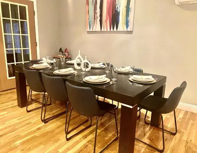 a black table with chairs and plates on it at Cedar Mill Hideaway in Woodbury