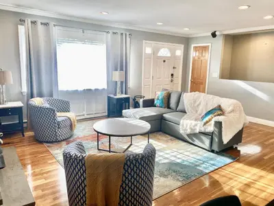 a living room with a couch and chairs and a table at Cedar Mill Hideaway in Woodbury