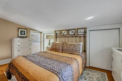 a bedroom with a bed and a dresser at A Bonnie Place in Oneonta