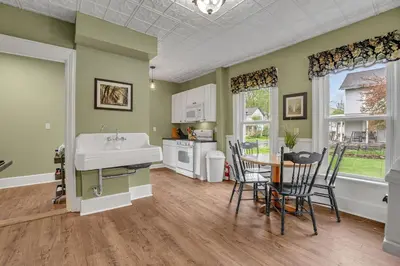 a kitchen with a sink and a table and chairs at Doyle House - Near Cooperstown Dreams Park 2 in Milford