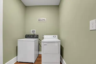 a laundry room with a stove and a washer and dryer at Doyle House - Near Cooperstown Dreams Park 2 in Milford