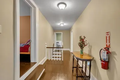 a hallway with a table and a chair in a room at Doyle House - Near Cooperstown Dreams Park 2 in Milford