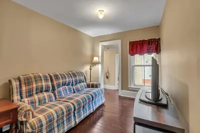 a living room with a couch and a flat screen tv at Doyle House - Near Cooperstown Dreams Park 2 in Milford