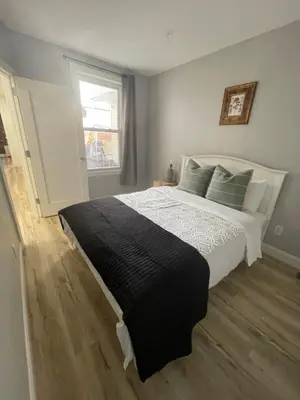 a bedroom with a large bed and a window at Modern Luxury Apartment near NYC in Jersey City