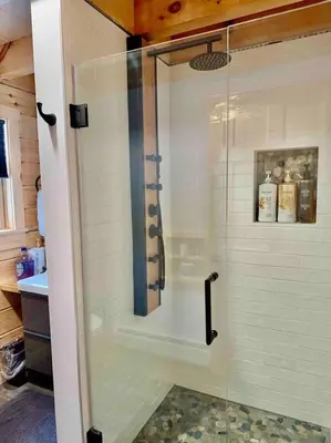 a shower with a glass door in a bathroom at Florida Mountain Log Cabin in Florida