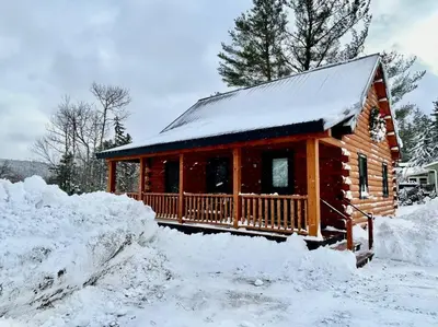 a log cabin in the snow with snow at Florida Mountain Log Cabin in Florida