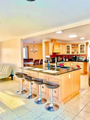 a kitchen with a island with bar stools at Scenic Views & River Access, Cozy River Home in Montague