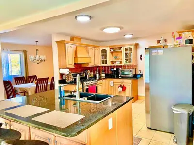 a kitchen with a sink and a refrigerator at Scenic Views & River Access, Cozy River Home in Montague
