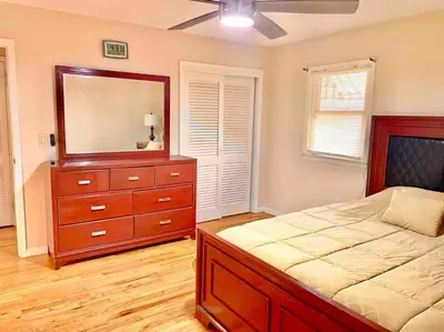 a bedroom with a bed and a dresser with a mirror at Scenic Views & River Access, Cozy River Home in Montague
