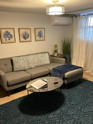 a living room with a couch and a coffee table at Morris Park area(very close to Jacobi Hospital in Morris Park