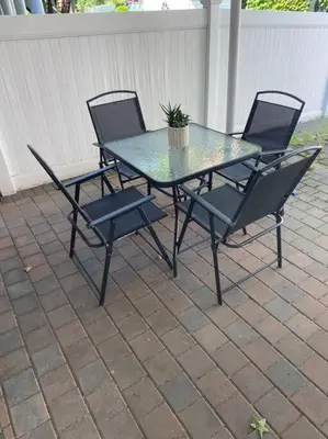 a patio table and chairs with a potted plant on it at Morris Park area(very close to Jacobi Hospital in Morris Park