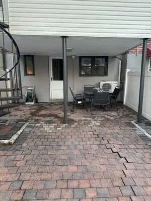 a patio with chairs and a table in a house at Morris Park area(very close to Jacobi Hospital in Morris Park
