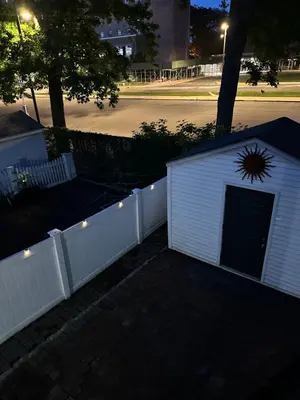 a white building with a gate and a fence at Morris Park area(very close to Jacobi Hospital in Morris Park