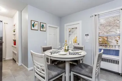 a dining room with a table and chairs and a window at 2 Bedroom Apartment Near Bristol Center in Bristol