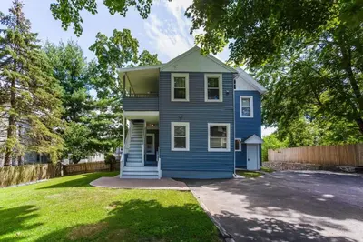 a blue house with a yard and a fence at 2 Bedroom Apartment Near Bristol Center in Bristol