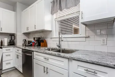 a kitchen with white cabinets and a sink at 2 Bedroom Apartment Near Bristol Center in Bristol