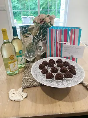a plate of brownies on a table with bottles of wine at Hilltop Mansion at Rebecca's Fountain in Niskayuna