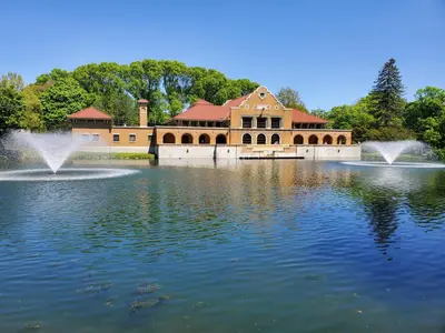 a building with a fountain in the middle of a lake at Hilltop Mansion at Rebecca's Fountain in Niskayuna