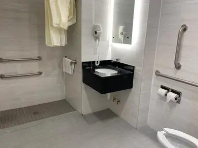 a bathroom with a sink and a phone on the wall at Royal Hotel Bronx in Bronx
