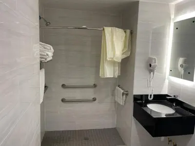 a bathroom with a toilet and a sink and a phone at Royal Hotel Bronx in Bronx