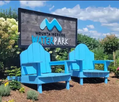 two blue benches in front of a water park sign at Great Gorge-ous condo in Vernon Township
