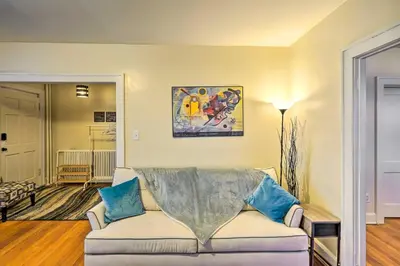 a living room with a couch and a painting on the wall at Charming Albany Retreat about 3 Mi to Downtown! in Albany