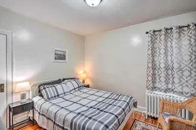 a bedroom with a bed and a chair and a window at Charming Albany Retreat about 3 Mi to Downtown! in Albany
