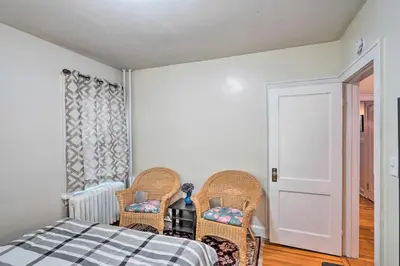 a bedroom with two wicker chairs and a bed at Charming Albany Retreat about 3 Mi to Downtown! in Albany