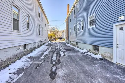 an alley between two buildings with snow on the ground at Charming Albany Retreat about 3 Mi to Downtown! in Albany