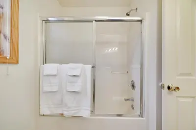 a bathroom with a shower with white towels at Luxury Spacious Home with some FREE Amenities and Activities! in Mushroom Farms