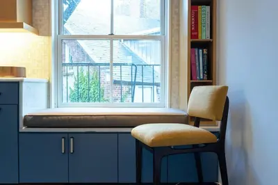 a chair sitting in front of a window at E10-3 3BR Designer Townhouse in New York