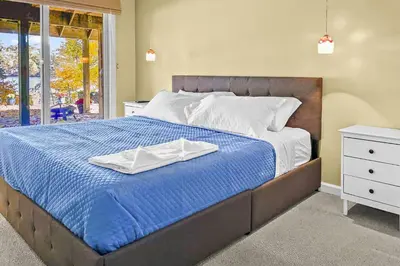 a bed with two white towels on top of it at Cottage at Sunny Day in Newtown