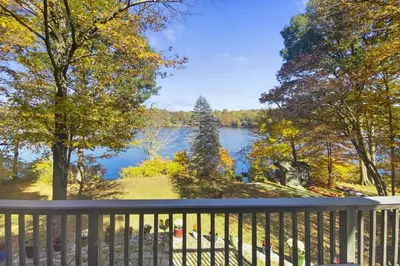 a balcony with a view of a lake at Cottage at Sunny Day in Newtown