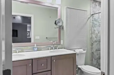 a bathroom with a sink and a toilet and a mirror at Cottage at Sunny Day in Newtown