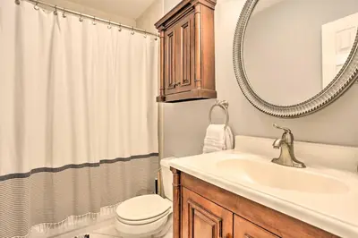 a bathroom with a sink and a toilet and a mirror at Hoboken Condo Walk to Public Transit! in Hoboken