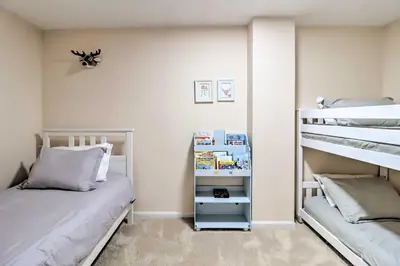a bedroom with a bunk bed next to a bunk bed gmaxwell gmaxwell gmaxwell at Gas Grill, Lake Access Scenic Poconos Retreat! in East Stroudsburg