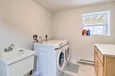 a laundry room with a washing machine and a sink at Gas Grill, Lake Access Scenic Poconos Retreat! in East Stroudsburg