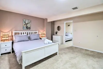 a bedroom with a large white bed and two lamps at Gas Grill, Lake Access Scenic Poconos Retreat! in East Stroudsburg