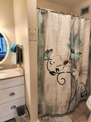 a bathroom with a shower curtain with butterflies on it at Gorgeous 1st FL Mtn View Jiminy Suite Sleeps 4 Ski On Off in Hancock