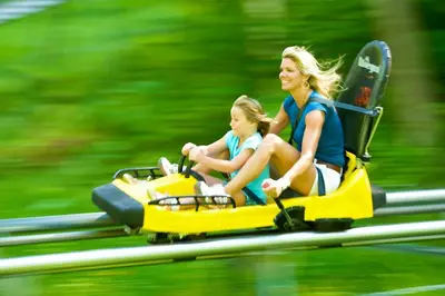 a woman and a child riding on a toy motorcycle at Gorgeous 1st FL Mtn View Jiminy Suite Sleeps 4 Ski On Off in Hancock